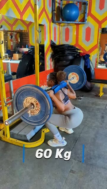 Personal training client squatting 60 kg during a strength session in Nairobi